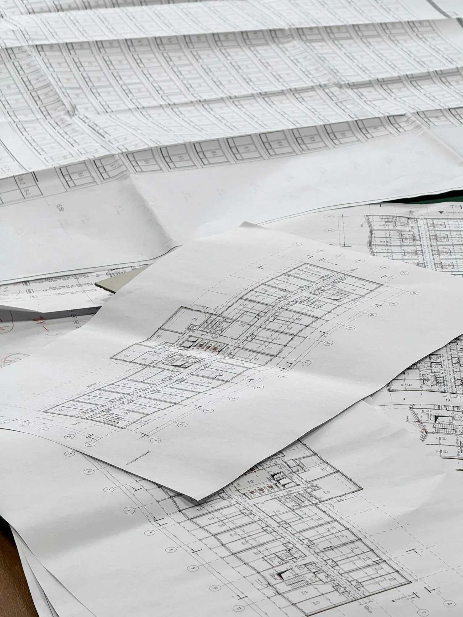 Architectural plans spread across a work surface